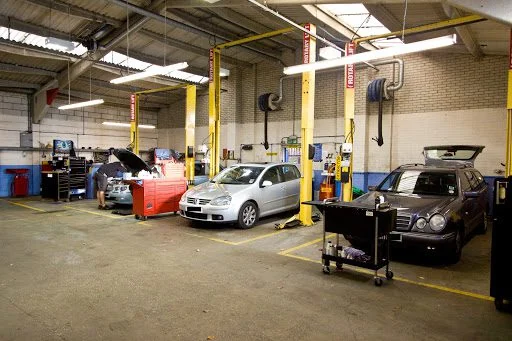 Technician working on a car in the Nev'll Fix It workshop bays